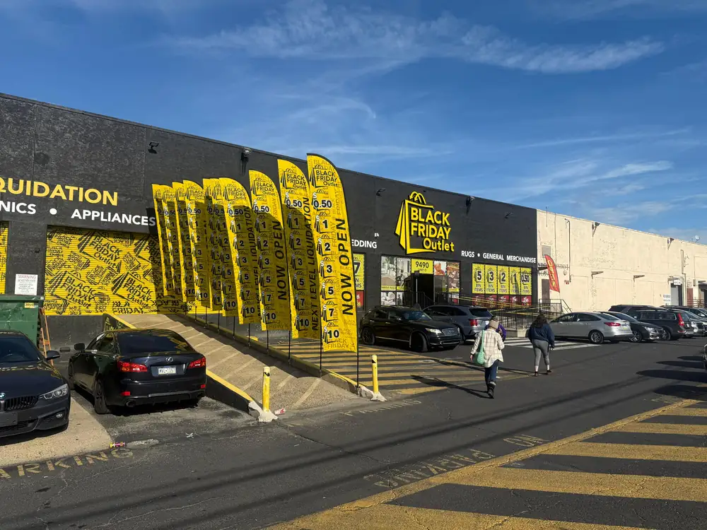 Yellow promotional feather flags outside a U.S. discount retail store