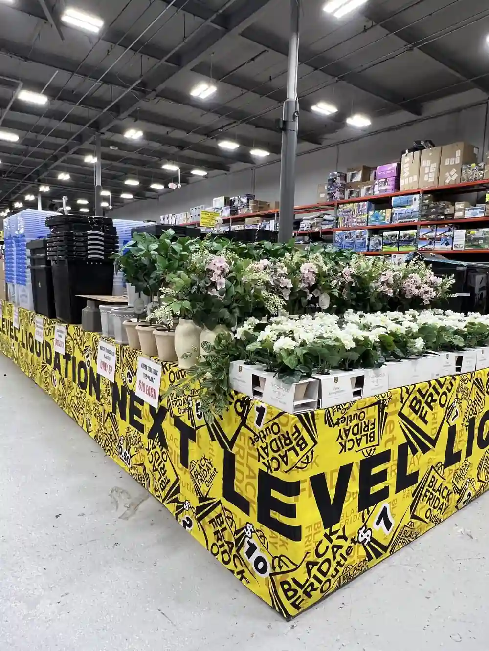Retail promotion banner surrounding an artificial flower and home decor display